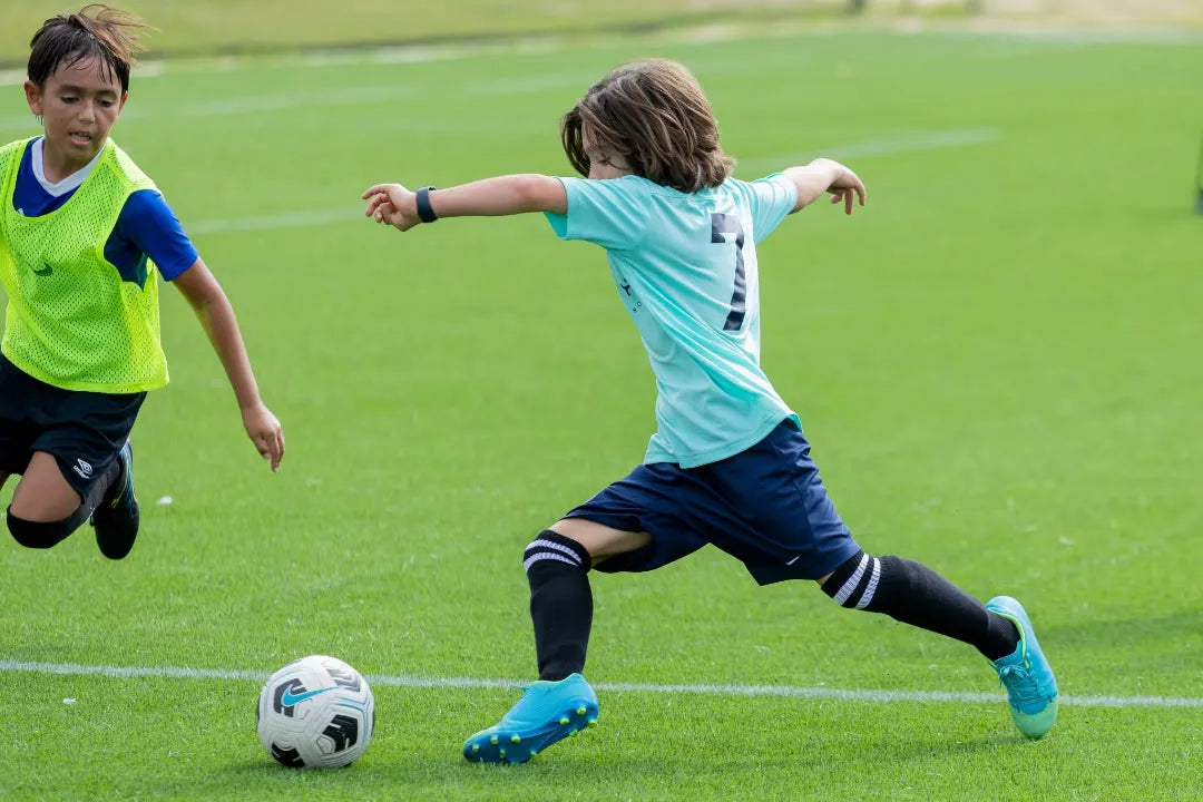 GFI Academy youth soccer players competing on a Houston-area field