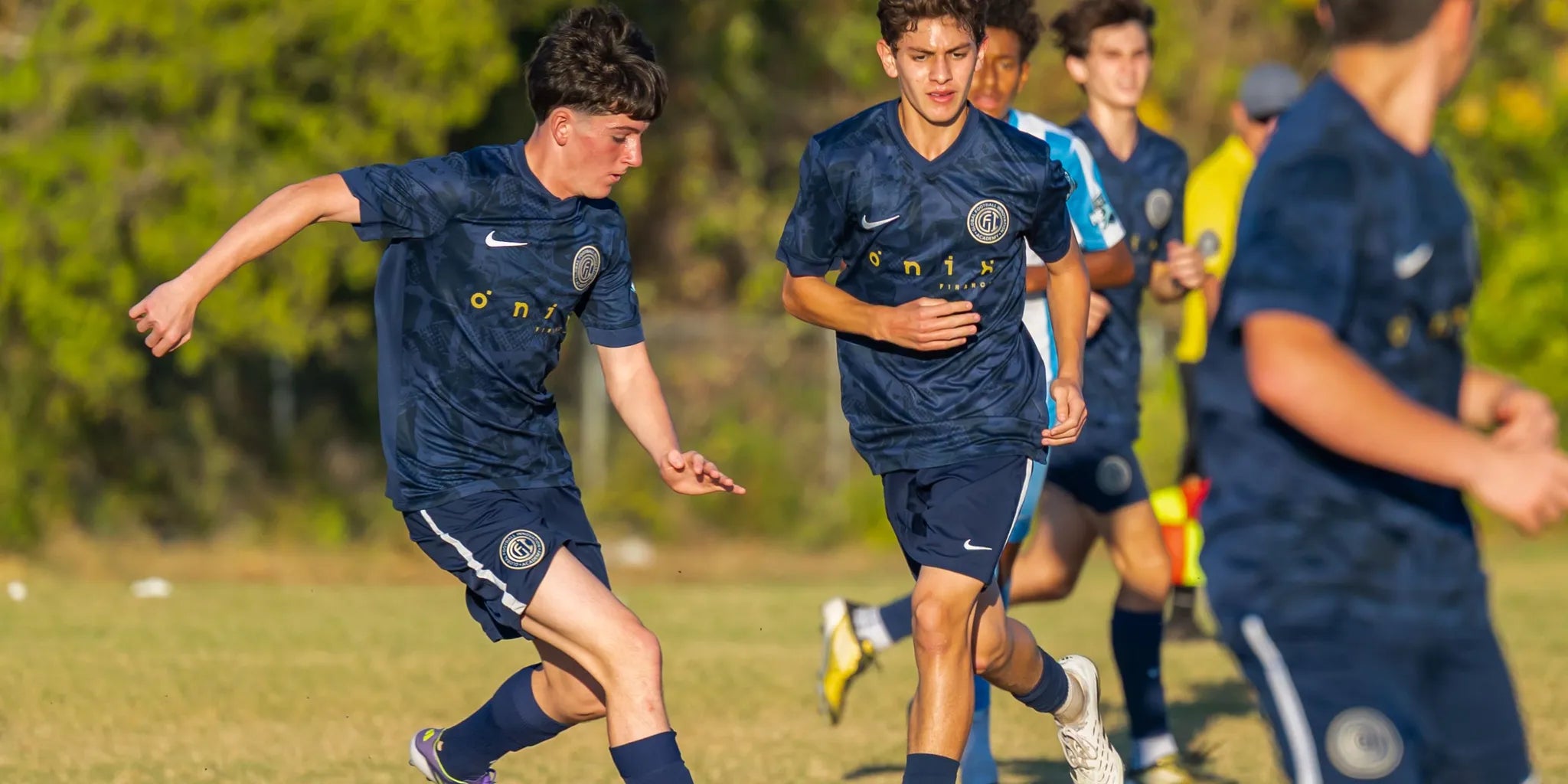 Youth soccer players training with a coach on a Greater Houston field